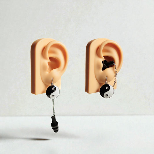 Yin and Yang Black and white earrings with earplugs in ear