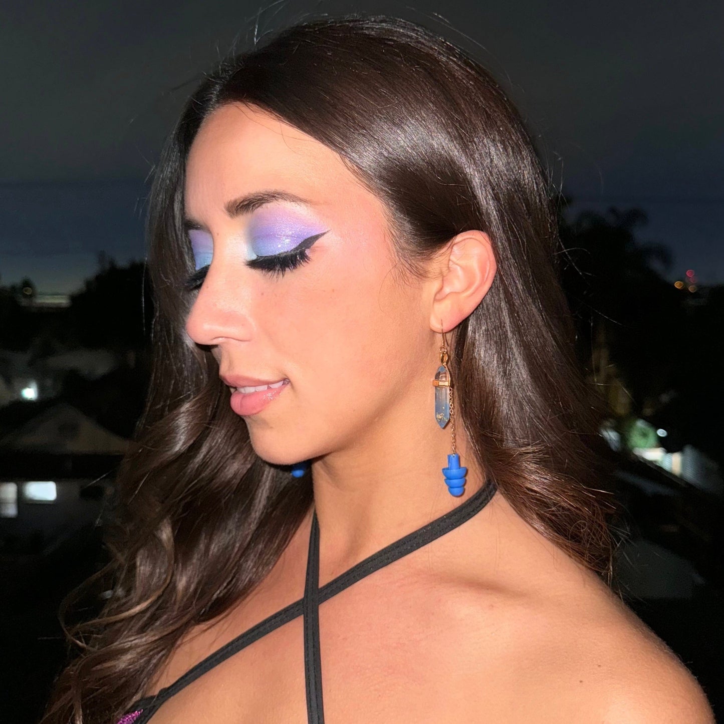 Elegant blue crystal earplug earrings with gold chains and matching earplugs. A fashionable accessory offering noise reduction for ravers and EDM fans.