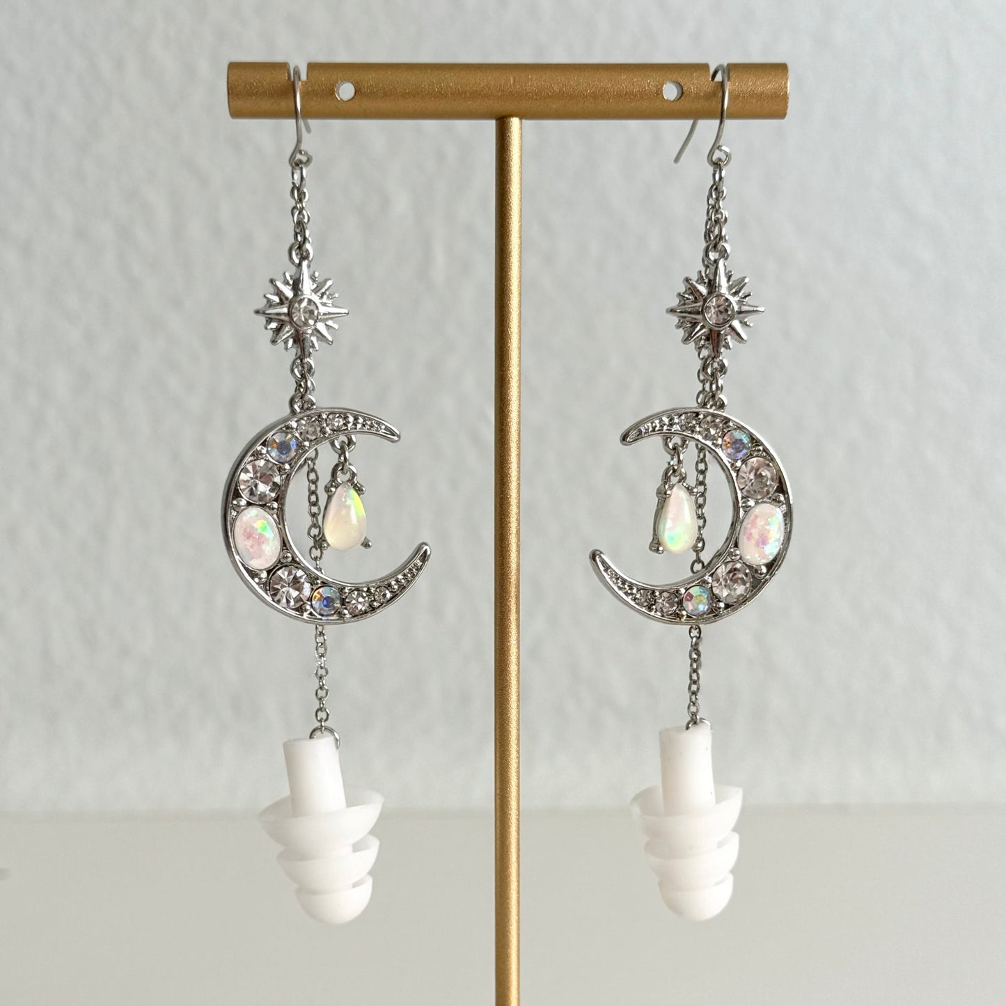 Crystal Moon earplug earring jewelry with white ear plugs attached. Zoomed in view of earrings.
