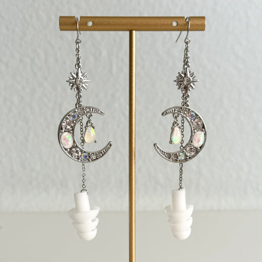 Crystal Moon earplug earring jewelry with white ear plugs attached. Zoomed in view of earrings.