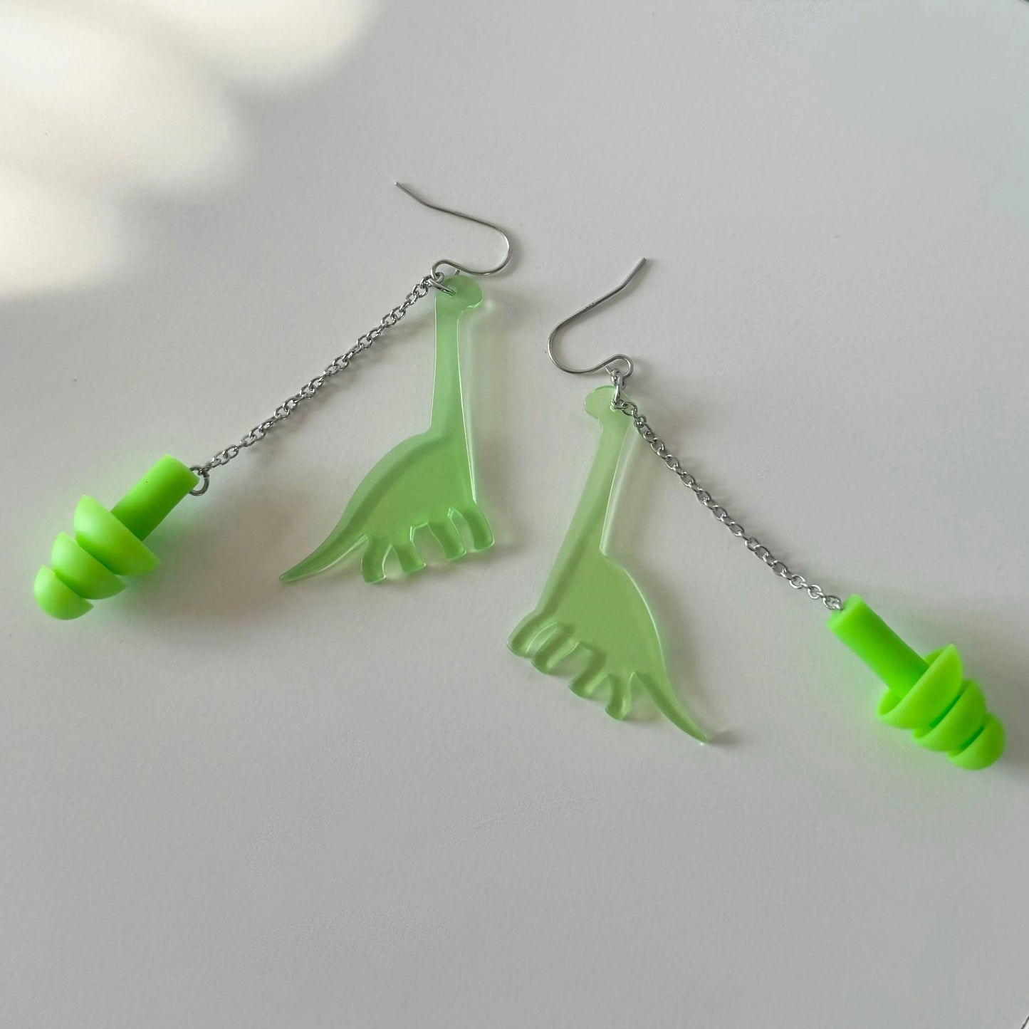 Dinosaur (Long Neck) Earplug Earrings Earrings from Rave Day. Perfect gift for ravers, music lovers, and anyone in need of hearing protection at loud events!