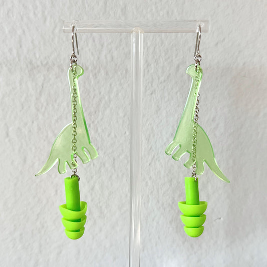 Zoomed in view of Dinosaur (Long Neck) Earplug Earrings Earrings from Rave Day. Perfect gift for ravers, music lovers, and anyone in need of hearing protection at loud events!
