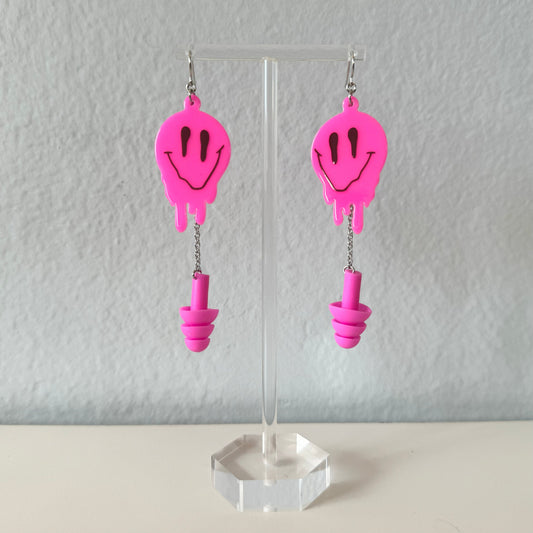 Zoomed in view of Hot Pink Melted Smiley Earplug Earrings. Perfect gift for ravers, these sensory-friendly earplugs provide hearing protection at events.
