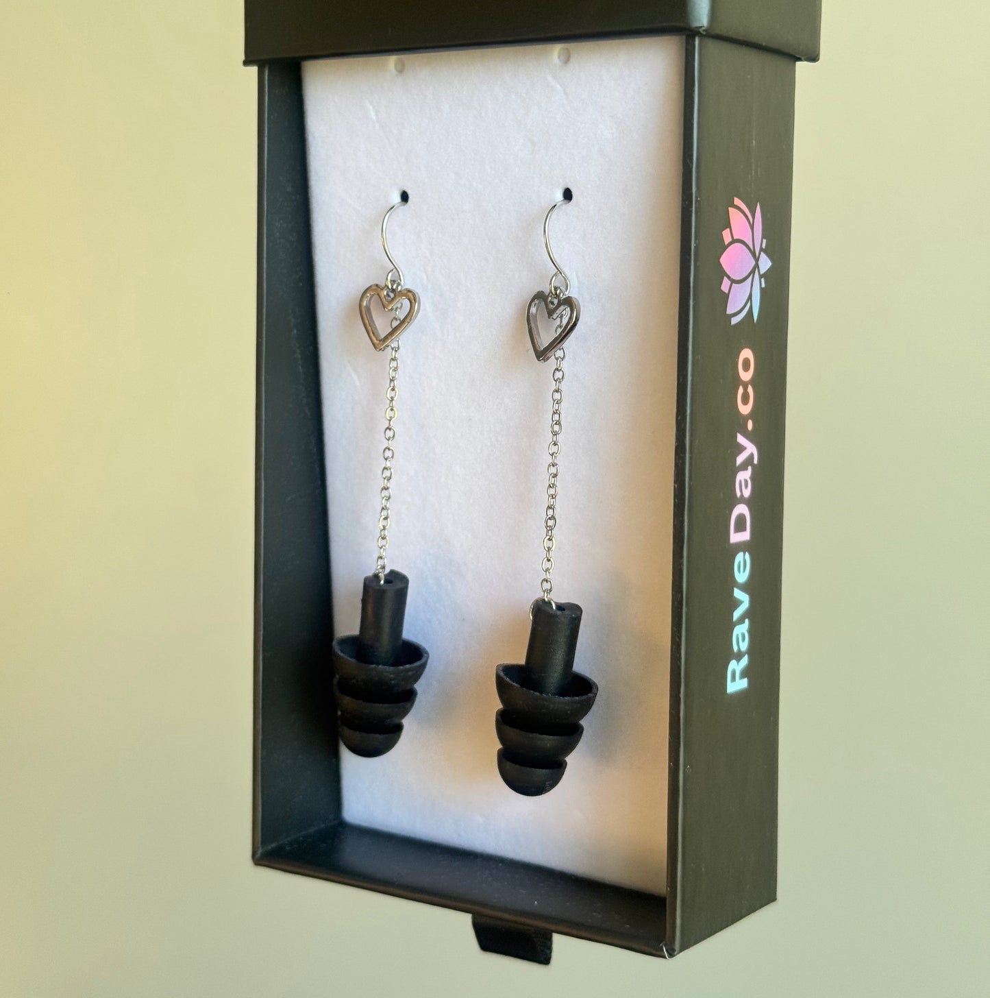 silver heart earplug earrings with black ear plugs in rave day box
