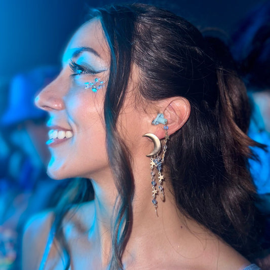 Cute rave girl wearing Gold moon Starry night chain drops. Earplug earrings with blue beads, perfect gift for ravers seeking style and hearing protection. Sensory-friendly earrings with attached earplugs.